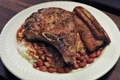 a white plate topped with meat and beans