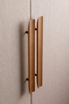 two wooden handles are attached to the wall