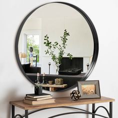 a mirror sitting on top of a wooden table