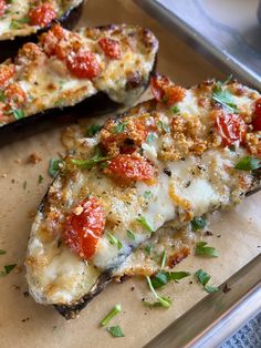 two slices of pizza sitting on top of a cutting board