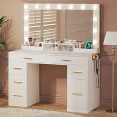 a white vanity with lights on it in a room