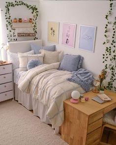 a bedroom with a bed, desk and dresser in the corner next to a window