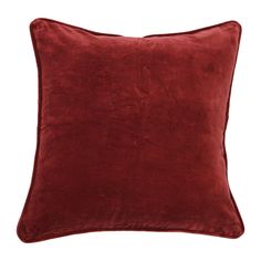 a red velvet pillow on a white background