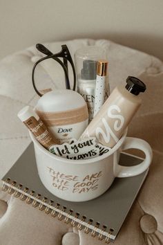 a cup filled with personal care items sitting on top of a notebook