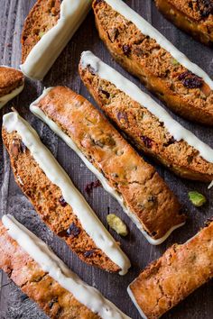 some type of bread with white icing on it and other food items around it