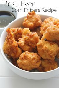 the best ever corn fritters recipe is in a white bowl with dipping sauce