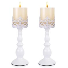 two white candles are sitting side by side