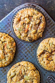 four muffins sitting on top of a baking pan filled with different types of food