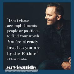 a man sitting in front of a black background with a quote on it