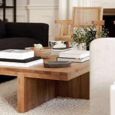 a coffee table with books on it in a living room