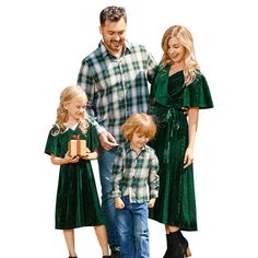 a man, woman and two children are holding presents while standing in front of a white background