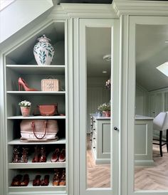 an open closet with shoes and handbags on the bottom shelf, next to other items