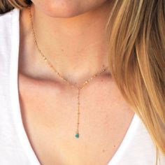 "Our lariat necklace is perfect minimalist jewelry. This dainty necklace is perfect with your favorite tee or your little black dress. A natural turquoise drop adorns a 14kt gold filled satellite chain.  D E T A I L S *Natural Arizona turquoise chips *2 inch drop  *Dainty satellite chain *100% 14kt gold dainty link chain  LENGTH *The standard length is normally 18\". *Model is wearing a 16\" in Photos. HOW TO PERSONALIZE *Select your choices from the drop down menu to create your custom design. Turquoise Lariat Necklace As A Gift, Turquoise Lariat Necklace Gift, Turquoise Charm Necklace With Adjustable Chain, Turquoise Charm Necklace With Delicate Chain, Turquoise Lariat Necklace With Adjustable Chain, Elegant Turquoise Lariat Necklace With Adjustable Chain, Adjustable Dainty Lariat Necklace, Elegant Turquoise Lariat Necklace For Gift, Necklace Minimalist Jewelry