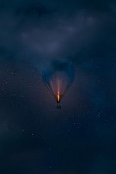 a hot air balloon flying through the night sky