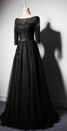 Black long sleeved dress for a woman's wedding Black Wedding Gown With Boned Bodice, Fitted Ball Gown With Long Train For Banquet, Fitted Gown With Corset Back For Banquet, Fitted Gown With Corset Back For Banquets, Black Fitted Mother Of The Bride Dress For Wedding, Evening Ball Gown Wedding Dress With Corset Back, Fitted Tulle Evening Dress With Sweep Train, Fitted Wedding Dress With Long Train For Prom Season, Fitted Dress With Sweep Train For Debutante Ball