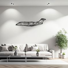 a living room with a couch, coffee table and potted plant on the wall