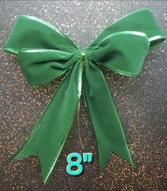 a green bow with the number eight on it