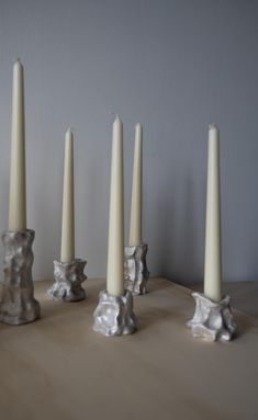 five candles are lined up on a table