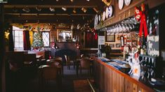 the bar is decorated for christmas with festive decorations on the wall and hanging from the ceiling