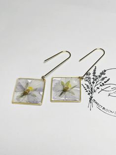 Real preserved pressed viola earrings. The earring hook is dipped in gold. I can guarantee you'll never find another beautiful hand crafted pair of earrings like this. All of my earrings are very lightweight.  *All flowers are grown and pressed by me *Due to the nature of all flowers, each pair may not be the exact length, width or color but I pair them as close as possible.  *All flowers are coated in epoxy to help the flower keep its natural shape. *This is a ready to ship item. *Each piece of jewelry is hand crafted and as unique as flowers are. Due to different display settings colors may appear differently on monitors than in real life. Since I use natural flowers, colors may vary. *The flowers I preserve are naturally pigmented. Therefore in order for this to maintain its natural col Delicate Dangle Earrings With Pressed Flowers, Botanical Drop Earrings With Pressed Flowers, Botanical Style Drop Earrings With Pressed Flowers, Botanical Pressed Flowers Dangle Earrings, Botanical Pressed Flowers Drop Earrings, Pressed Flower Drop Earrings, Botanical Flower Drop Earrings, Botanical Birth Flower Dangle Earrings, Viola Flower