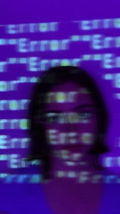 a blurry photo of a woman's face in front of a purple background