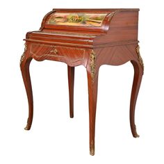 an antique desk with a painting on it