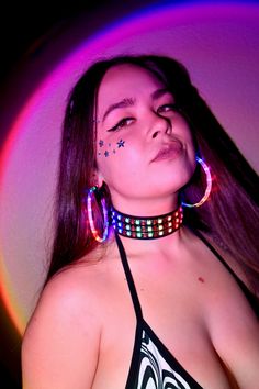 Expand your glow-filled wardrobe with the LED Choker Necklace. This colorful accessory features bright LED lights that respond to music, flashing and glittering to the beat of your favorite songs. Adjustable around your neck, this choker sits comfortably, and the battery pack fits comfortably on your back, so you hardly notice it's there. This quality-crafted sound-reactive LED Choker Necklace is a must for night concerts, festivals, and rave parties. It has bright, colorful lights that glitter Rave Jewelry For Music Festival With Adjustable Fit, Trendy Neon Jewelry For Party, Multicolor Rave Jewelry For Party, Rave Multicolor Choker For Festivals, Rave Style Multicolor Choker, Black Glow In The Dark Jewelry For Parties, Black Glow In The Dark Party Jewelry, Constellation Earrings, Colorful Lights