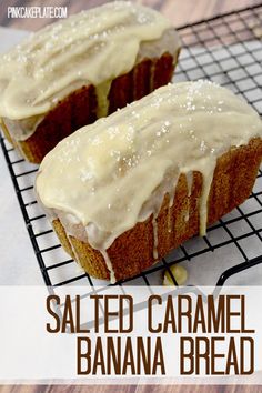 two glazed banana breads sitting on top of a cooling rack with icing drizzled over them