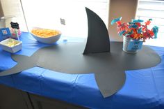 a shark shaped table with some snacks on it