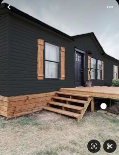 a mobile home with steps leading up to the front door and stairs down to the porch