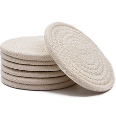 four white round coasters stacked on top of each other