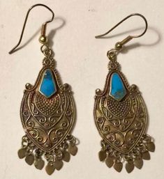 These lovely pair of dangling turquoise earrings are an estate find in Atlanta and appear to be made of brass or bronze with inlay turquoise. Estimated to date to the 1980s (90s at the latest), the earrings have the look of Balinese jewelry based on the metal work and styling. The little French hooks appear to be replacements and are unmarked. These would be easily swapped out by the next buyer if desired. In good vintage preowned condition, these are free of damage or repair. I'm selling this p Turquoise Bohemian Brass Jewelry, Bohemian Turquoise Brass Jewelry, Blue Teardrop Earrings With Patina, Ornate Antique Finish Dangle Earrings, Festival Turquoise Jewelry With Matching Earrings, Blue Pierced Copper Earrings, Blue Copper Pierced Earrings, Turquoise Brass Jewelry For Festivals, Festival Turquoise Metal Earrings