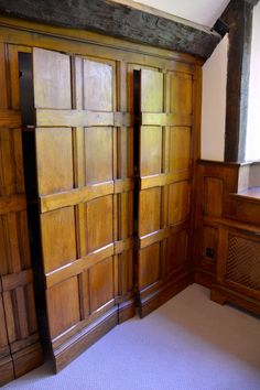 an empty room with wooden doors and carpet