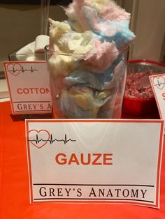 there is a glass with some candy in it on top of a table that says gauze grey's anatomy