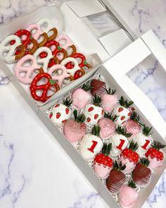 a box filled with lots of different types of strawberries and pretzels next to each other