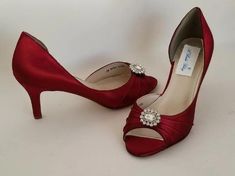 Deep Red Bridal Shoes with crystal design, perfect for the bride or her bridesmaids. FEATURES: Medium heel (2 1/2 inches) Satin upper Leather Sole Sparkling Crystals Peep toe Designed in the USA If you are concerned about ordering the correct size, please consider adding our try before we dye service. We send you a sample wedding shoe to try on. You return the Wedding Shoes to us (at your expense) and let us know if this is the correct size for your final pair or if you would like a different si Dyed Shoes, Deep Red Wedding, Red Bridal Shoes, Bridesmaids Shoes, Red Wedding Shoes, Custom Wedding Shoes, Beach Wedding Sandals, Ivory Bridal Shoes, Beach Wedding Shoes