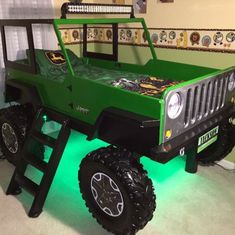 a green jeep is parked in a room