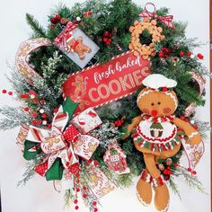 a christmas wreath with gingerbreads and cookies on it