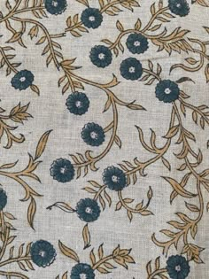 an embroidered fabric with blue flowers on it