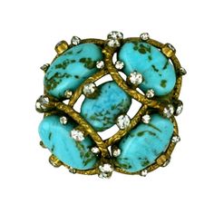 One of Mlle. Chanel's most popular brooch designs. Handmade Pate de verre beads made to simulate turquoise matrix set in a gilded bronze web scattered with pastes. Often purchased and worn in pairs,these brooches were frequently seen on the jet set such as Jackie O. Another exact example of this brooch is exhibited from October 1, 2020 at Pallais Galleria , Paris in "Gabrielle Chanel, Manifeste de Mode exhibition, which pays tribute to the iconic designer until March 14, 2021. See last image Pls Chopard Jewelry, Shades Of Turquoise, Chanel 2, Chanel Jewelry, Couture Vintage, Band Jewelry, Turquoise Stones, Vintage Chanel, Vintage Jewellery