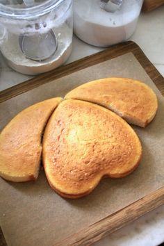 three pieces of bread sitting on top of a cutting board