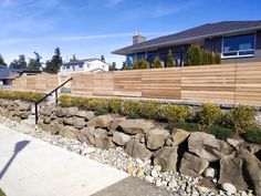 there is a rock wall in front of the house that has been fenced off