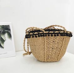 "This elegant crossbody straw bag is touched with adorable black mini pom poms around the edge. Fully lined with black cotton fabric and features with twisted shoulder straps. Perfect for spring and summer vacation or a trip to the beach. Material: straw Closure: drawstring Measurement: 12\" wide x 8.5\" high Shoulder strap: 16\" drop Color: camel brown 1 Interior pocket for cellphone Very convenient for beach goers. Ready to Ship from Los Angeles, California." Casual Summer Bucket Bag With Tassels, Vacation Black Straw Bucket Bag, Black Straw Crochet Bag For Beach Season, Handwoven Black Bucket Bag For Vacation, Summer Beach Bucket Bag With Tassels, Black Bucket Bag With Braided Handles For Beach Season, Black Handwoven Bucket Bag For Vacation, Summer Vacation Bucket Bag With Tassels, Black Straw Bucket Beach Bag