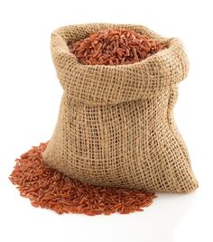 a bag full of red rice sitting on top of a white table