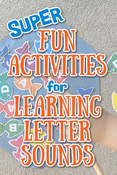 a child's hand is holding up a letter sound book with the words super fun activities for learning letter sounds