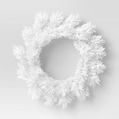 a white christmas wreath hanging on the wall