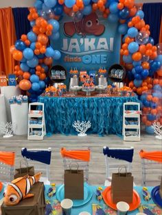 an under the sea themed birthday party with balloons and desserts on display for guests to eat