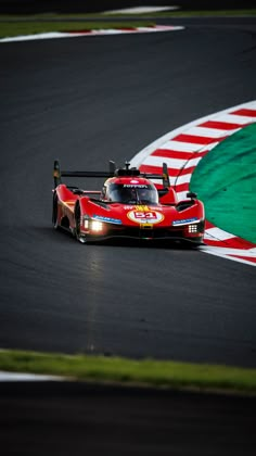 a red race car driving on a track