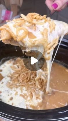 a crock pot filled with food being spooned into the slow - cooker