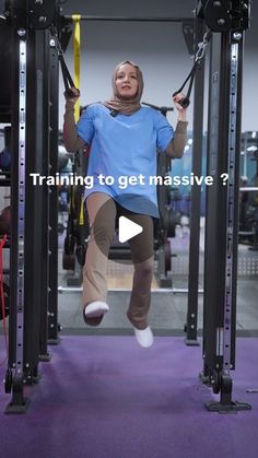 a woman is doing pull ups on a machine in the gym with text reading training to get massive?